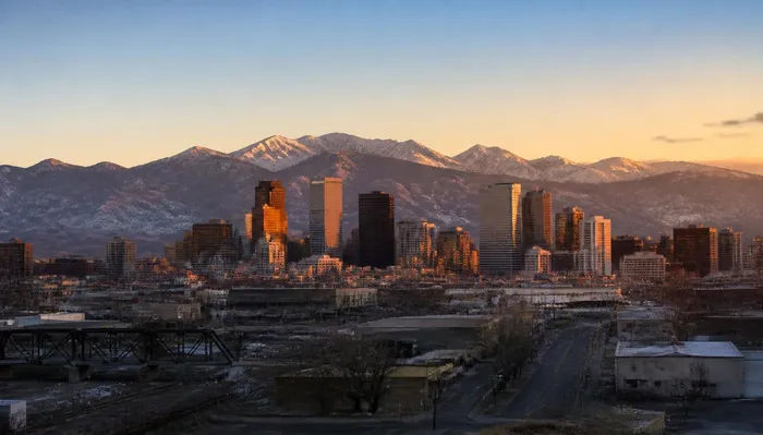Denver skyline at dawn with the Front Range behind it